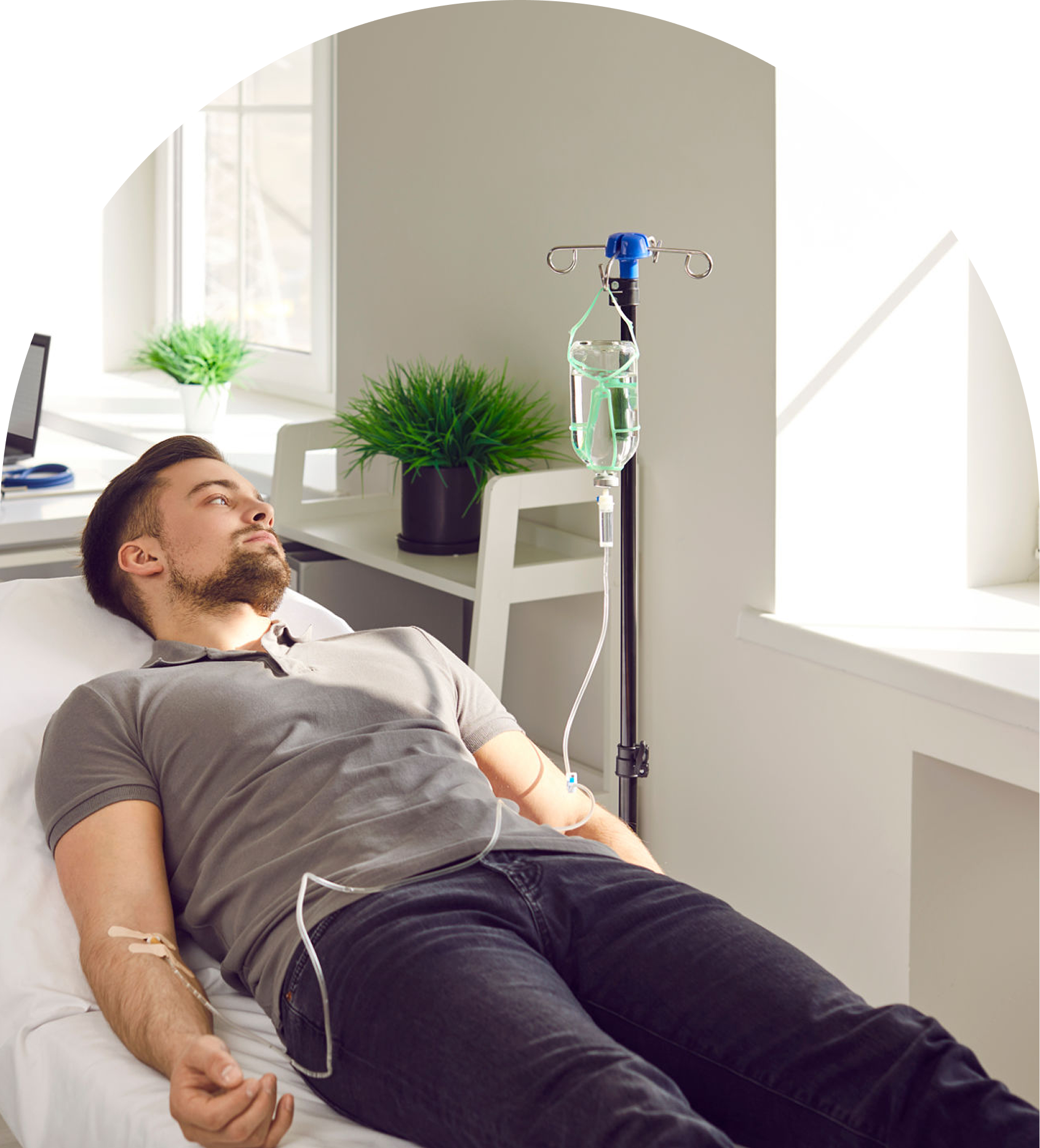 Man receiving IV therapy in clinic.