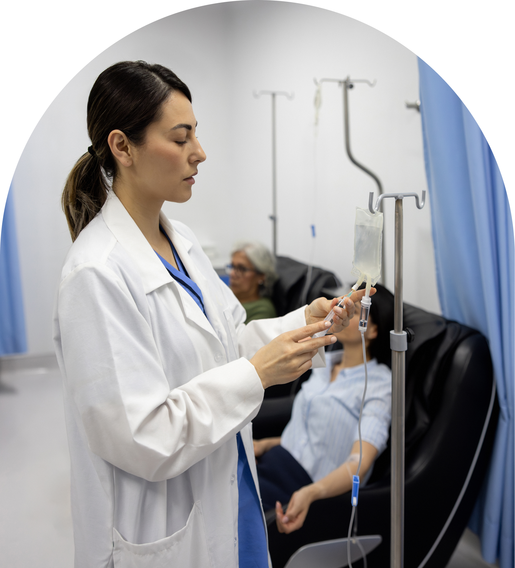 Nurse preparing IV for patient in hospital.